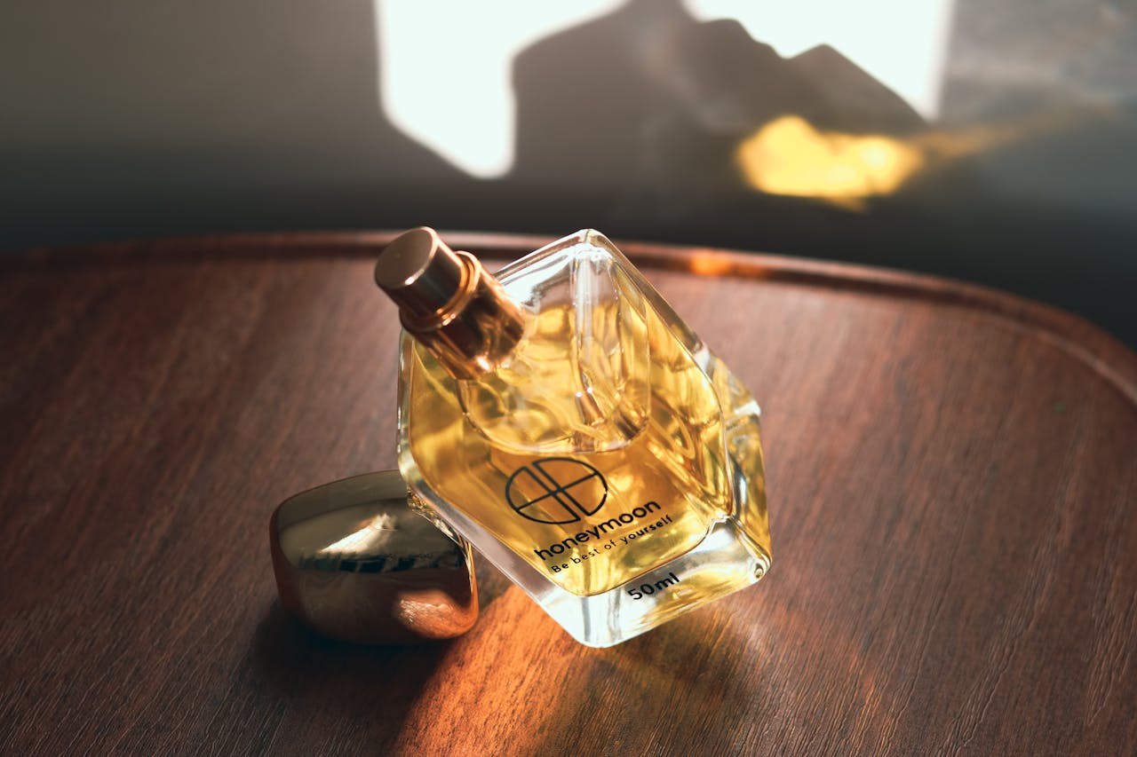Capture the essence of elegance with this uniquely shaped perfume bottle on a wooden surface.